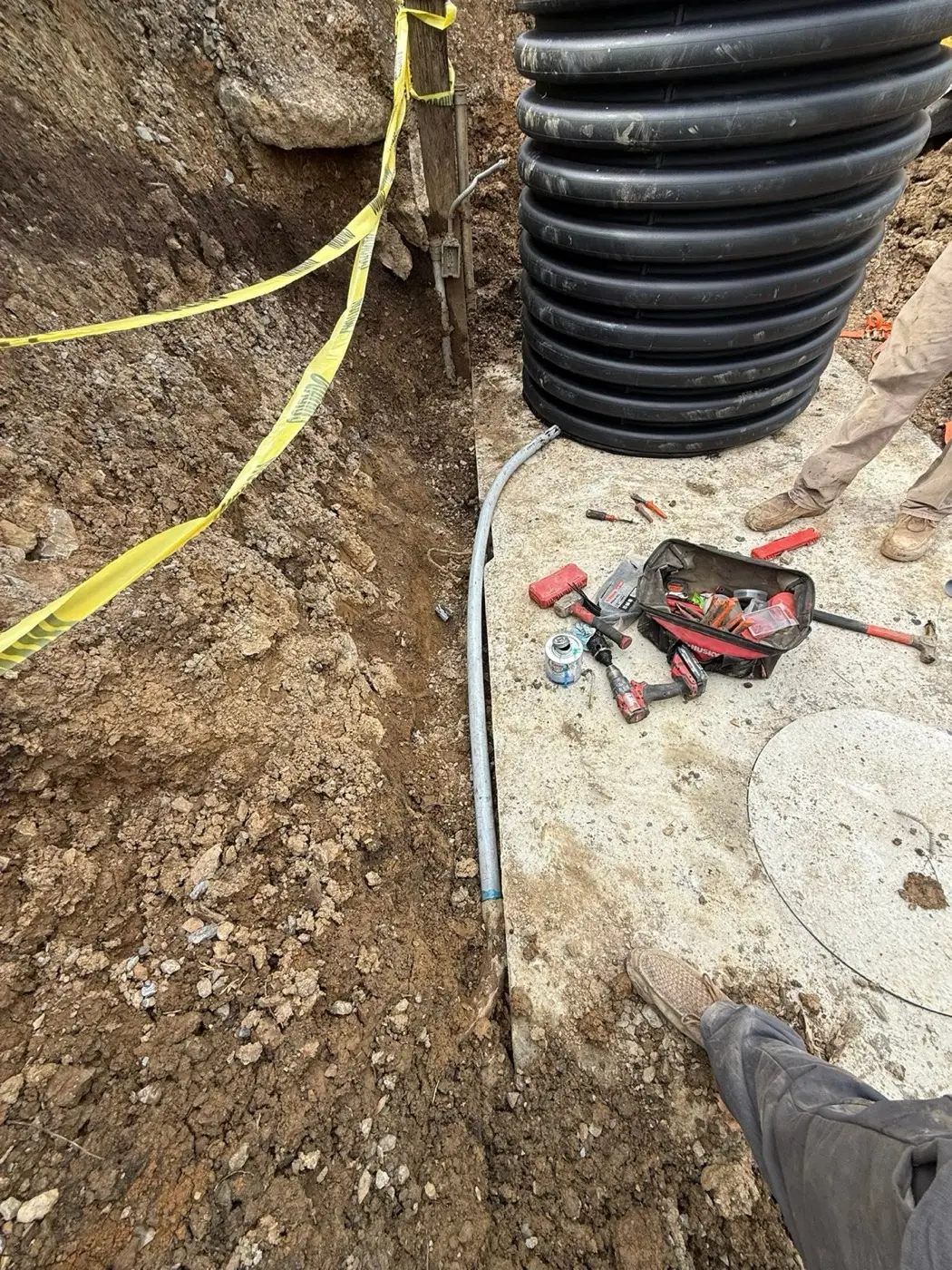 Water line and conduit set in a rocky trench